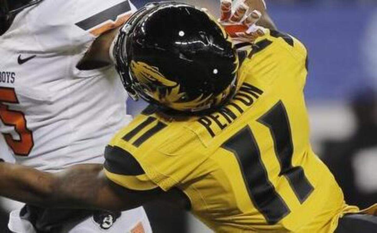 
Missouri defensive back Aarion Penton (11) tried to tackle Oklahoma State wide receiver Josh Stewart in the Cotton Bowl last season. Penton grew up in the northern St. Louis suburbs.


