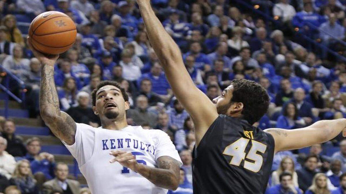 Kentucky's Willie Cauley-Stein (left) an Olathe Northwest graduate, shot under pressure from Missouri's Keanau Post (45) in the second half Tuesday night at Rupp Arena in Lexington, Ky. The No. 1-ranked Wildcats beat the Tigers 86-37.