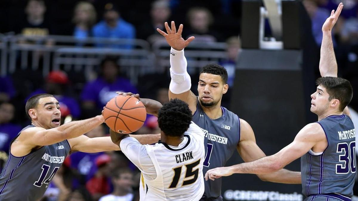Missouri’s Wes Clark was stopped in his tracks by a trio of Northwestern defenders, including Tre Demps (from left) Joey Van Zegren and Bryant McIntosh in the first half of Tuesday night’s CBE Hall of Fame Classic third-place game at the Sprint Center. Northwestern won the game 67-62.