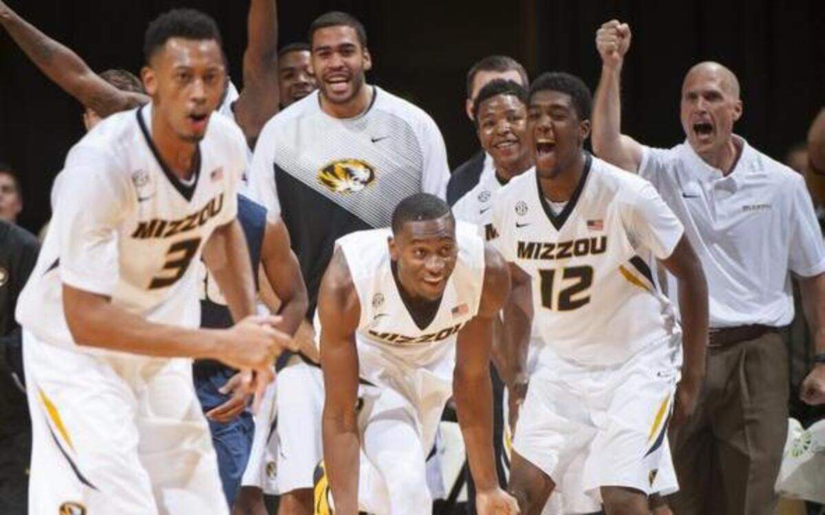 Missouri's Deuce Bello, center, celebrates making a 3-point shot in front of the Missouri bench during the second half of an NCAA college basketball game against Oral Roberts on Wednesday, Nov. 19, 2014, in Columbia, Mo. Missouri won 78-64.