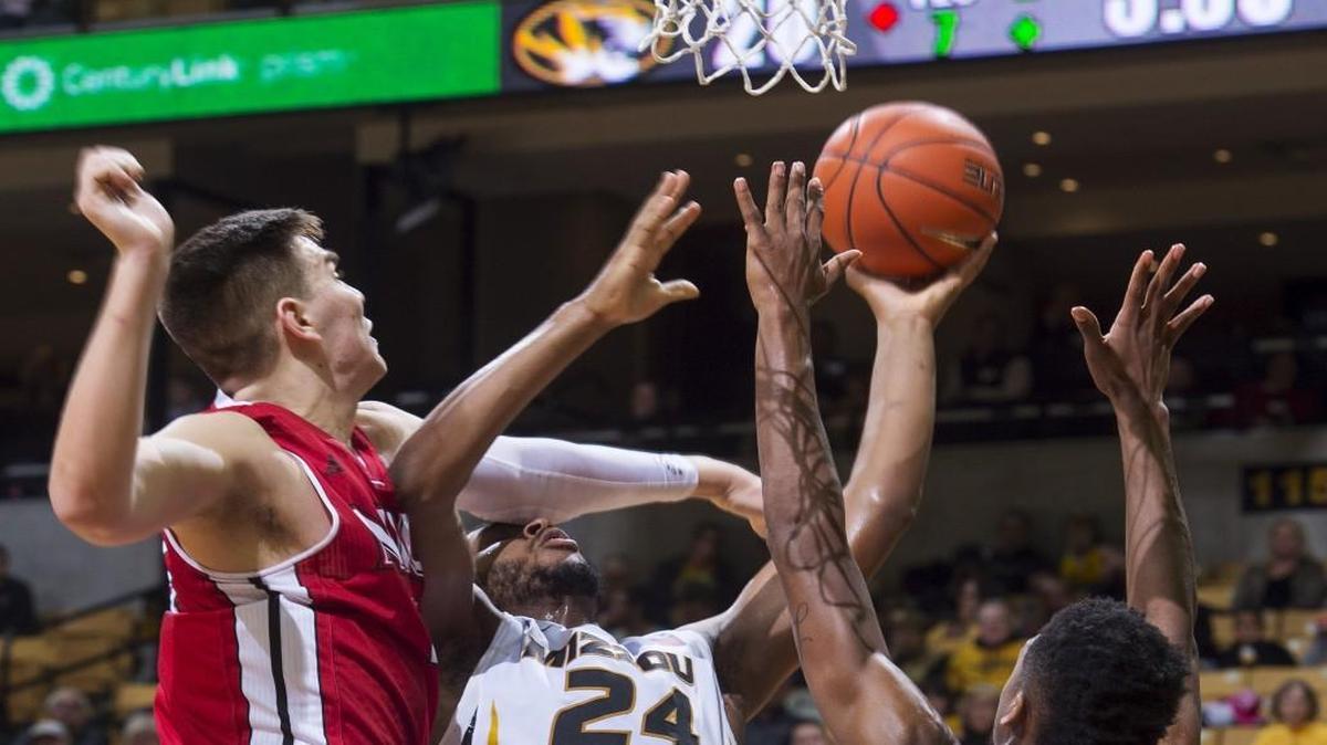 Northern Illinois's Marin Maric (left) and Levi Bradley (right) battle Missouri's Kevin Puryear for a rebound during Friday’s college basketball game in Columbia.