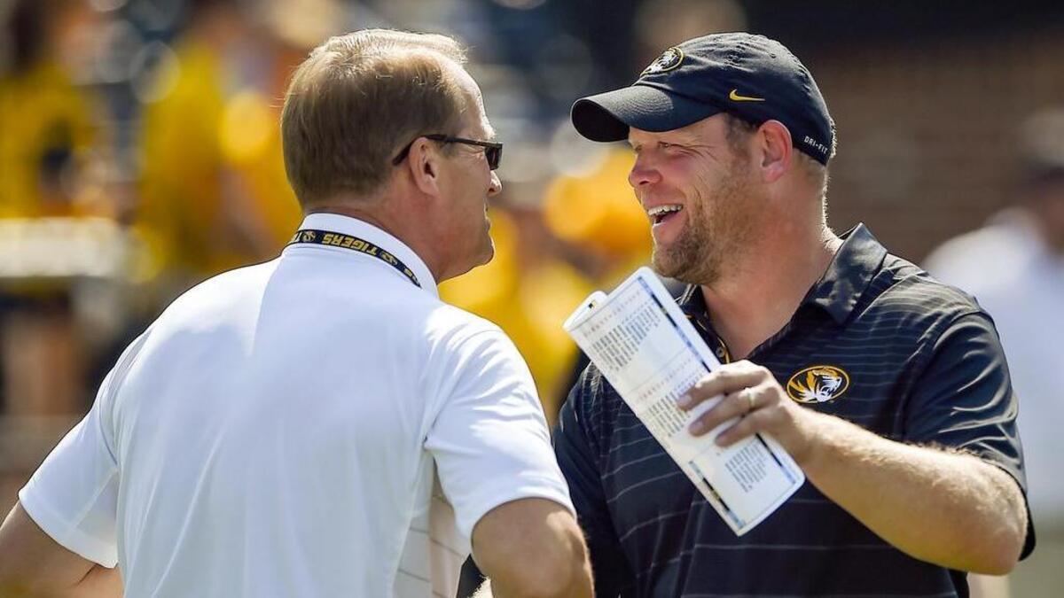 Missouri coach Barry Odom (right) will be handsomely rewarded if his Tigers become eligible for a bowl game.