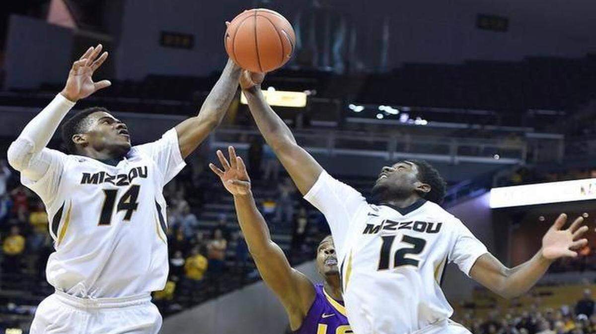 
After a late LSU miss, MU's Keith Shamburger (14) and Namon Wright gathered in the final rebound and MU went on to beat LSU, 74-67 in overtime Thrusday night at Mizzou Arena.

