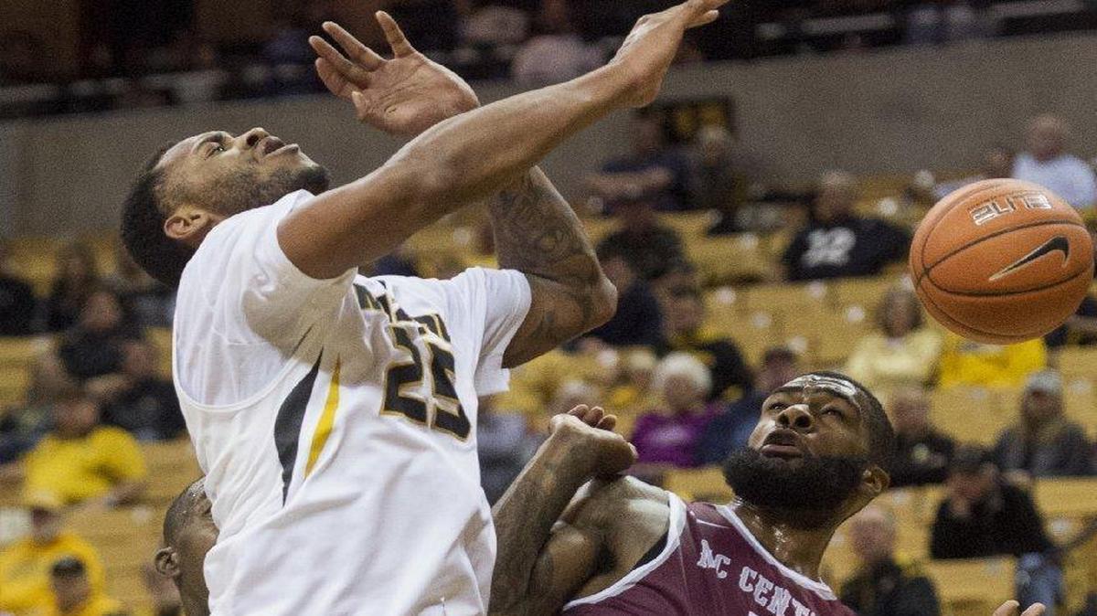 Missouri’s Russell Woods (left) had the ball knocked away by North Carolina Central’s Del’Vin Dickerson in the first half of the Tigers’ 62-52 loss Monday in Columbia.