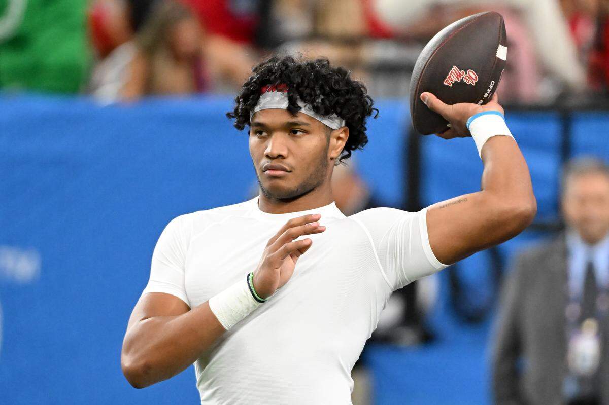 Austin Simmons #13 of the Ole Miss Rebels warms up prior to the 2025 College Football Playoff Semifinal at the VRBO Fiesta Bowl against the Miami Hurricanes at State Farm Stadium on January 8, 2026 in Glendale, Arizona.