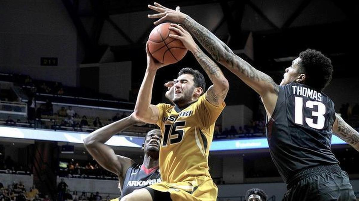 Arkansas’ Dustin Thomas (13) blocks a shot by Missouri’s Jordan Geist (15) during the first half of last season’s game at Mizzou Arena in Columbia, Mo.