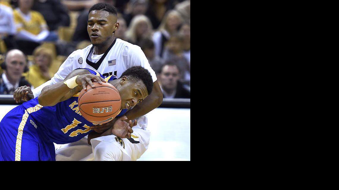 
UMKC's Martez Harrison drives by MU's Keith Shamburger during the second half of Friday night's game at Mizzou Arena. UMKC won, 69-61.
