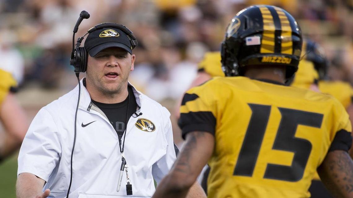 Missouri football coach Barry Odom (left) and Keyon Dilosa