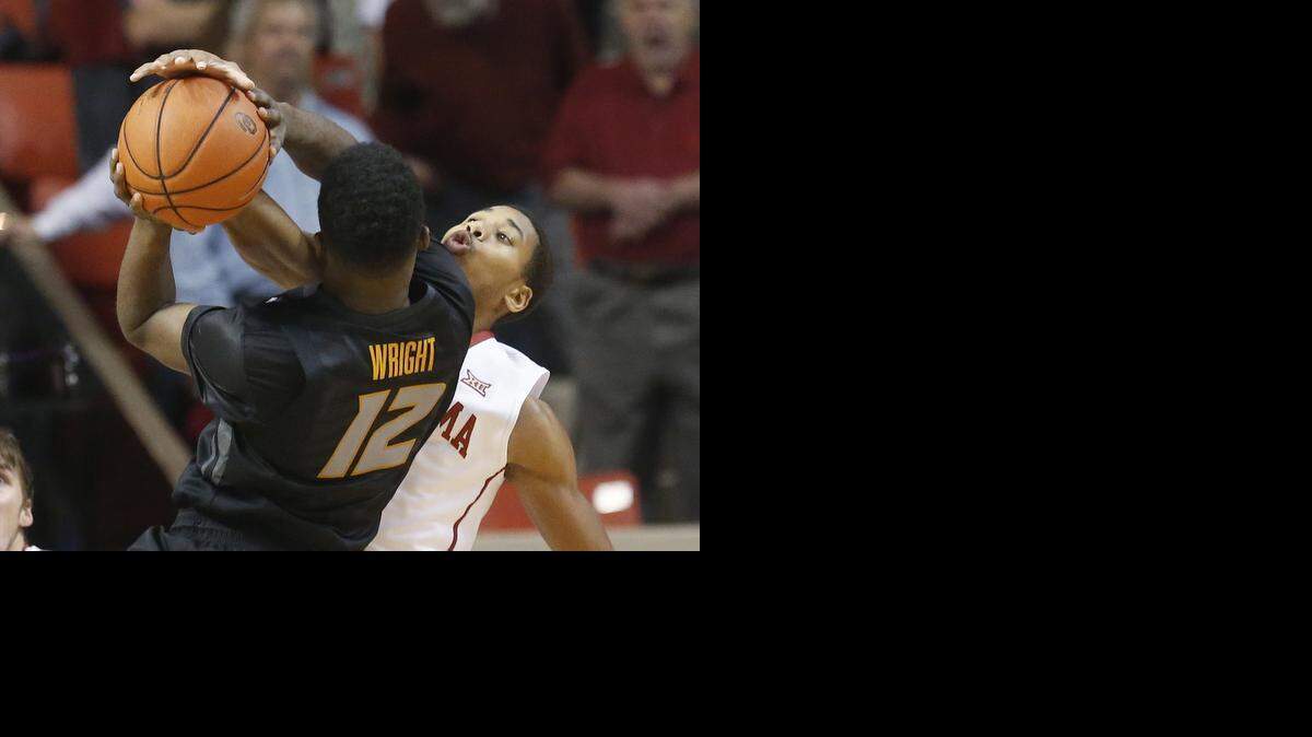 
Oklahoma guard Isaiah Cousins, right, gets his hand on the ball as Missouri guard Namon Wright (12) shoots in the first half of an NCAA college basketball game in Norman, Okla., Friday, Dec. 5, 2014. 
