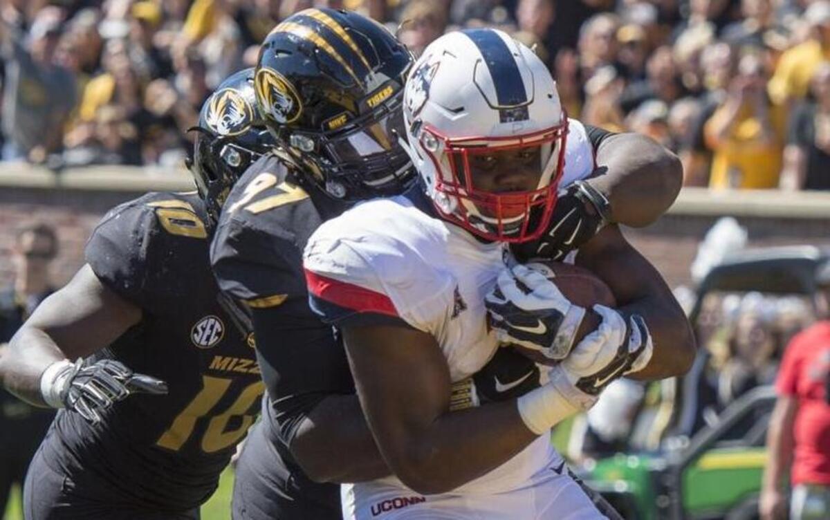 Tigers’ defensive lineman Josh Augusta (center) stopped Connecticut’s Ron Johnson for a one-yard loss in a September 2015 game in Columbia.