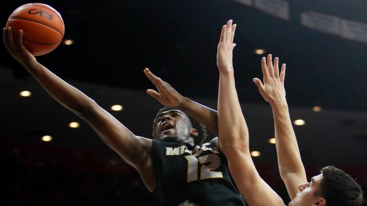 Missouri guard Namon Wright (12) shot over Arizona center Dusan Ristic in the first half Sunday night in Tucson, Ariz.