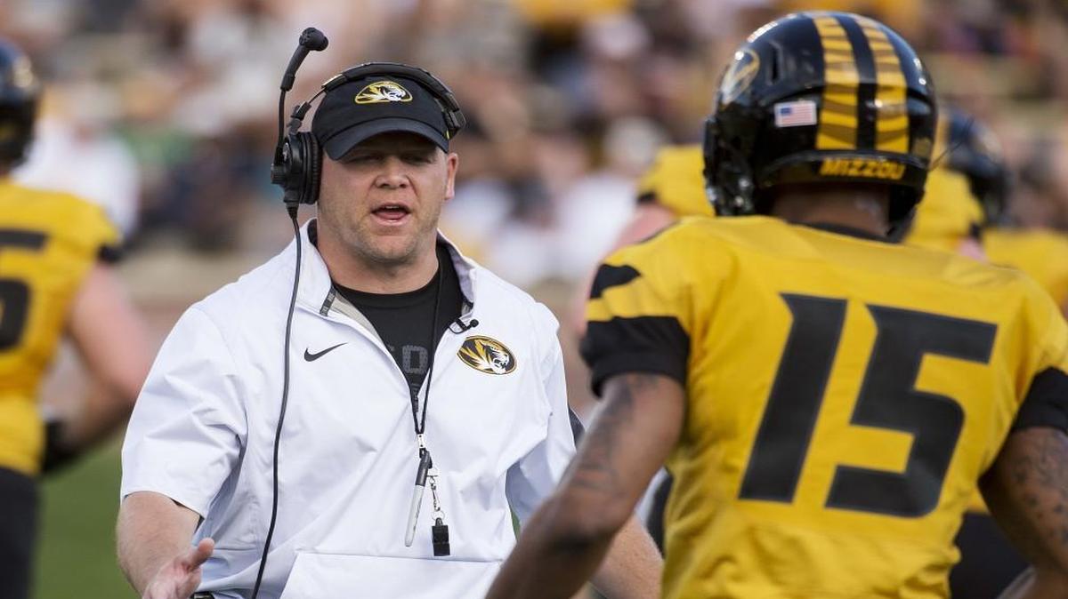 Missouri head coach Barry Odom (left).