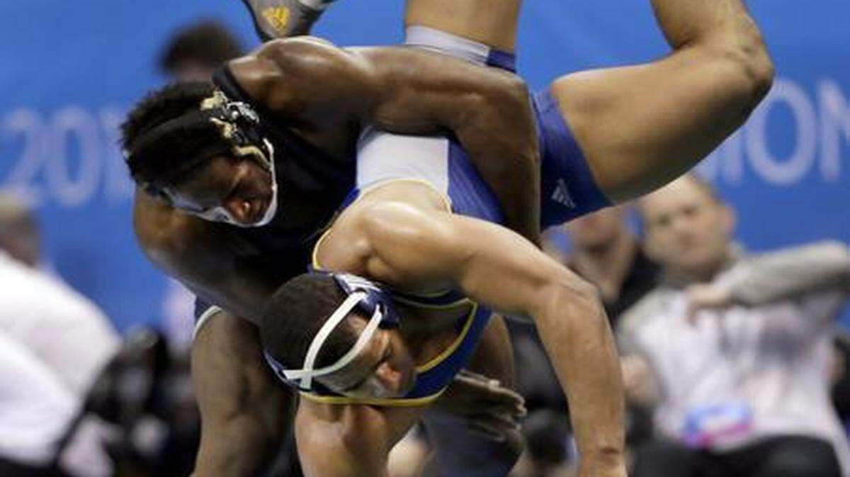 
Missouri's J’den Cox (left) beat Chattanooga’s Scottie Boykin in a 197-pound first-round match on Thursday at the NCAA championships on Friday in St. Louis.
