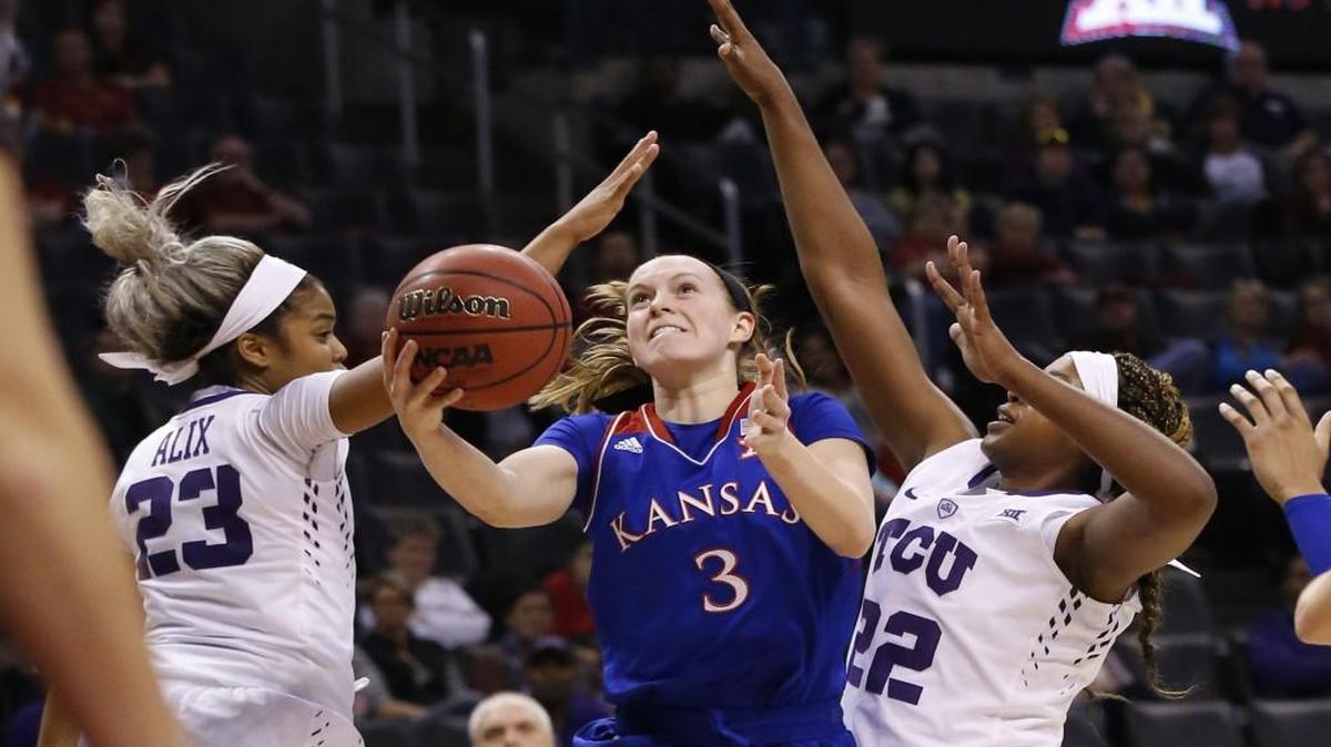 Lauren Aldrdige (center) led Kansas last season with averages of 11.1 points and 2.35 assists per game. Earlier this month she drove to the basket between TCU’s A.J. Alix (left) and Jordan Moore in a game in the Big 12 women’s tournament in Oklahoma City.