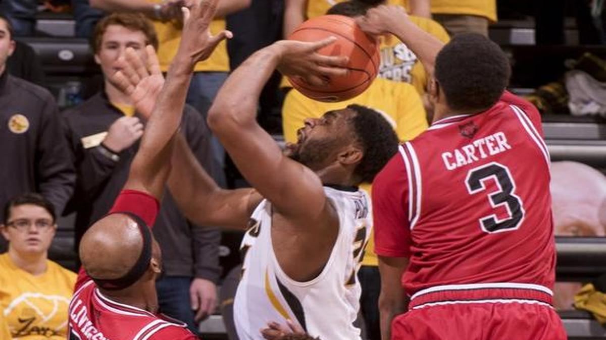 Missouri’s Kevin Puryear (center) tried to shoot while surrounded by Arkansas State’s Devin Carter (from right), P.J. Hardwick and Anthony Livingston in the second half Tuesday night in Columbia. The Tigers beat the Red Wolves 88-78 to improve to 3-3 this season.