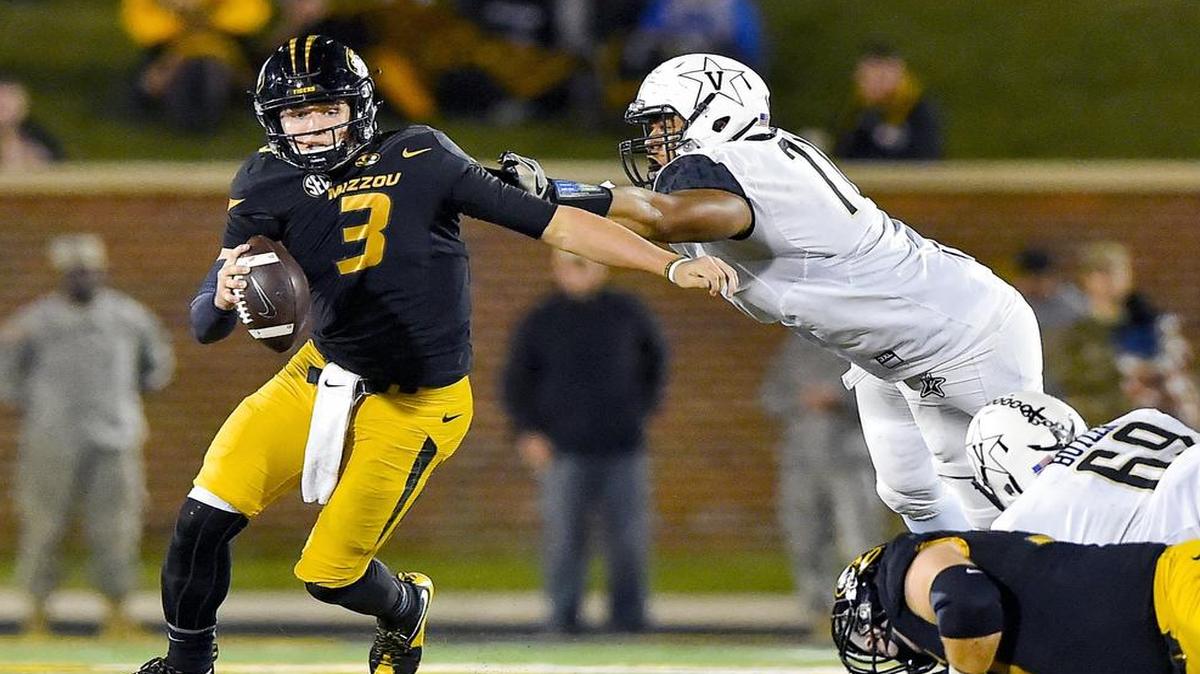 Missouri Tigers quarterback Drew Lock (3) managed to escape the grasp of Vanderbilt Commodores defensive tackle Nifae Lealao (77) during the fourth quarter of a college football game on Saturday, Nov. 11, 2016, in Columbia. Mizzou defeated the Commodores, 26-17, for the Tigers first SEC win of the season.