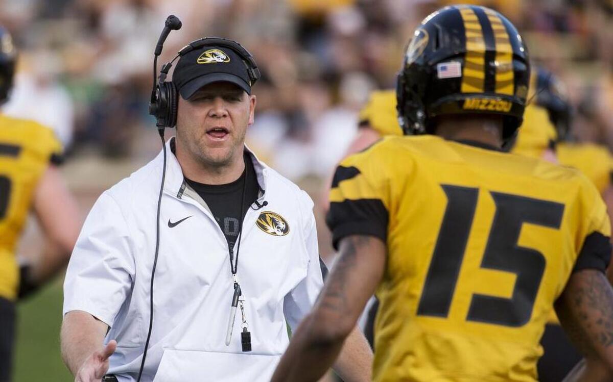 Missouri football coach Barry Odom, left, talks to player Keyon Dilosa, right, during the Tigers’ spring game on Saturday, April 16, 2016, in Columbia, Mo.