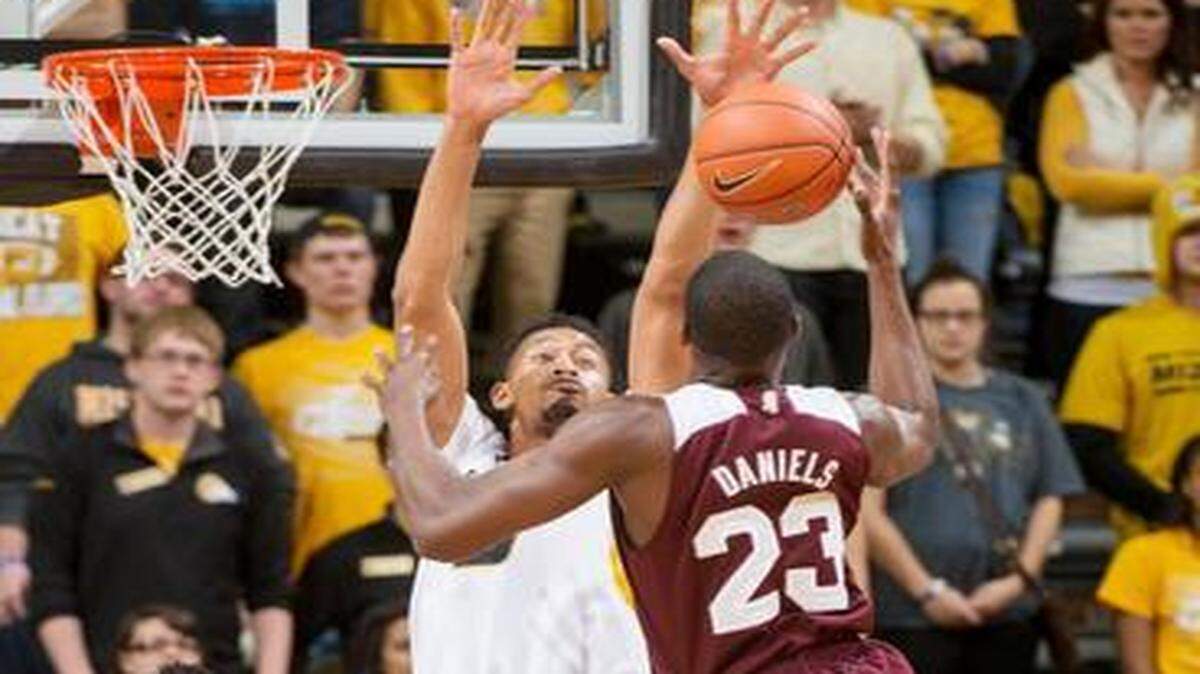 Mississippi State's Travis Daniels, right, has his shot blocked by Missouri's Johnathan Williams III, center, as Missouri's Namon Wright, left, looks on during the first half of an NCAA college basketball game Saturday, Feb. 14, 2015, in Columbia, Mo.