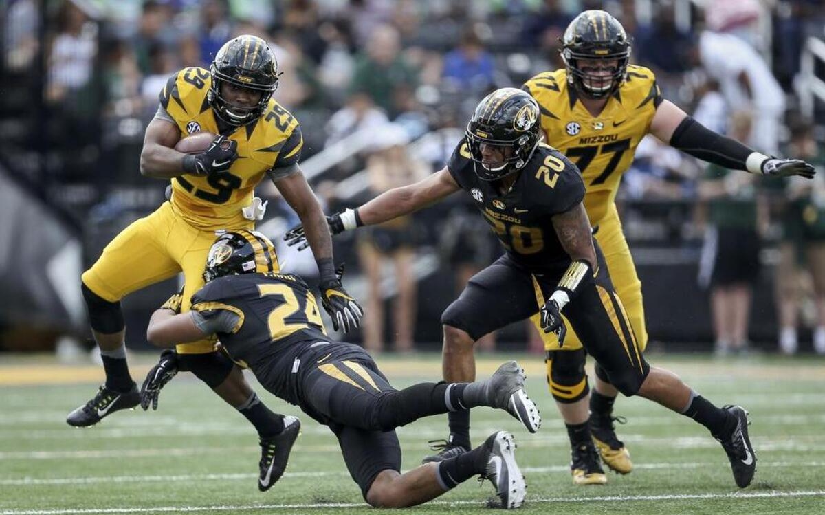 Missouri linebacker Terez Hall (24) tackles running back Nate Strong (29) as Kaleb Prewett (20) closes in during the team's spring game on Saturday, April 15, 2017, in Columbia, Mo.