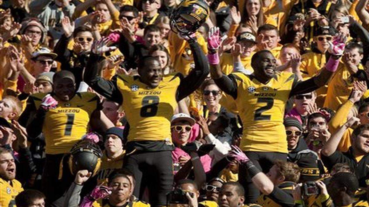 
Missouri’s L’Damian Washington, right, Darius White, center, and John Gibson, left, celebrated with fans after Mizzou defeated Florida 36-17 last October. 
