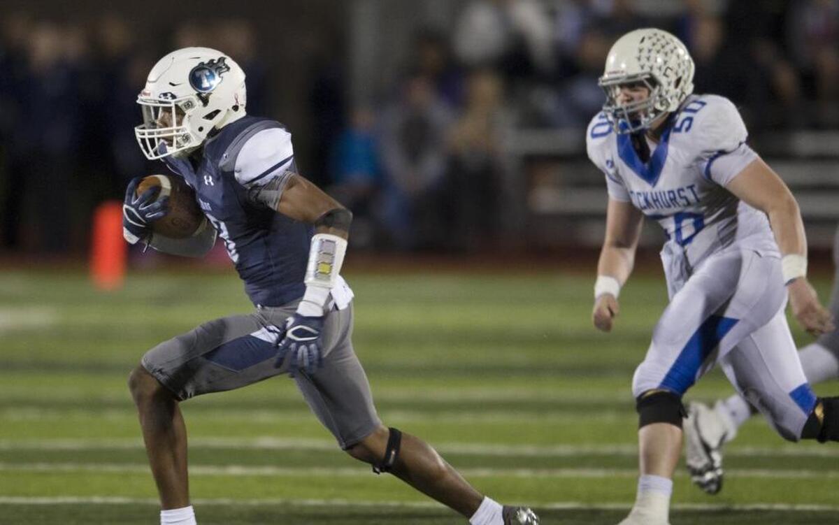 Lee’s Summit West’s Mario Goodrich (left) was one of several football recruits to visit the University of Missouri on Sunday as part of Junior Day. In this play from last season, Goodrich intercepted the ball and scored on the play during the first half of the district championship game against Rockhurst at Lee’s Summit West.