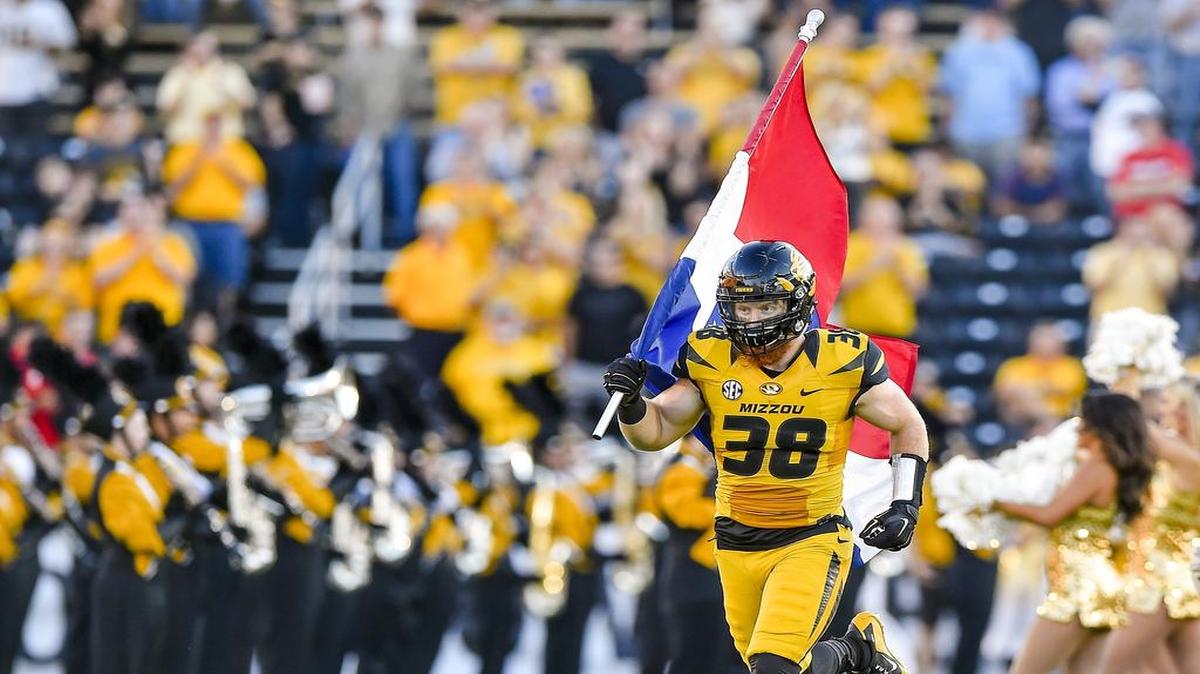 Missouri linebacker Eric Beisel carried the Missouri state flag onto Faurot Field before the Tigers played Georgia.