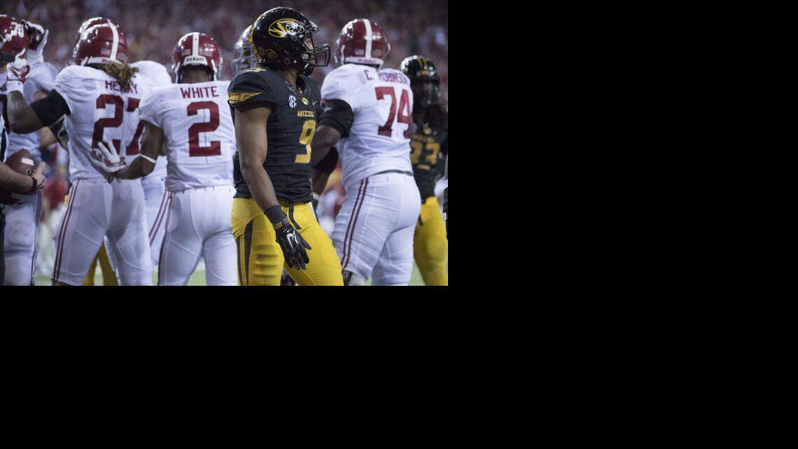 
Missouri Tigers safety Braylon Webb (9) looks toward the sideline as Alabama Crimson Tide running back Derrick Henry (27) celebrates a touchdown with team mates in the fourth quarter during the University of Missouri and University of Alabama SEC Championship football game in the Georgia Dome on Saturday, December 6, 2014, in Atlanta, Georgia. Alabama beat Missouri 42-13. Missouri falls to 0-4 all time in conference championship games.
