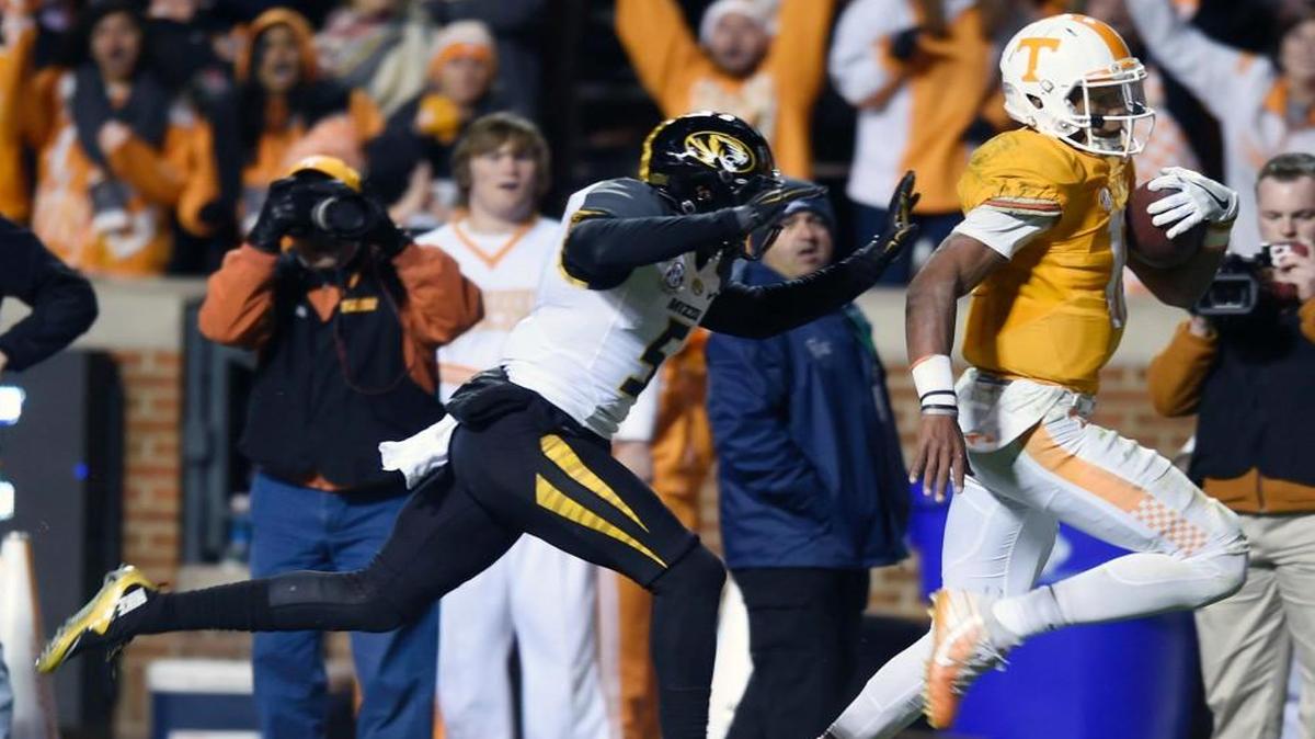 Tennessee quarterback Josh Dobbs ran away from Missouri defensive back John Gibson on his way to a touchdown in the second half of Saturday’s game in Knoxville, Tenn.