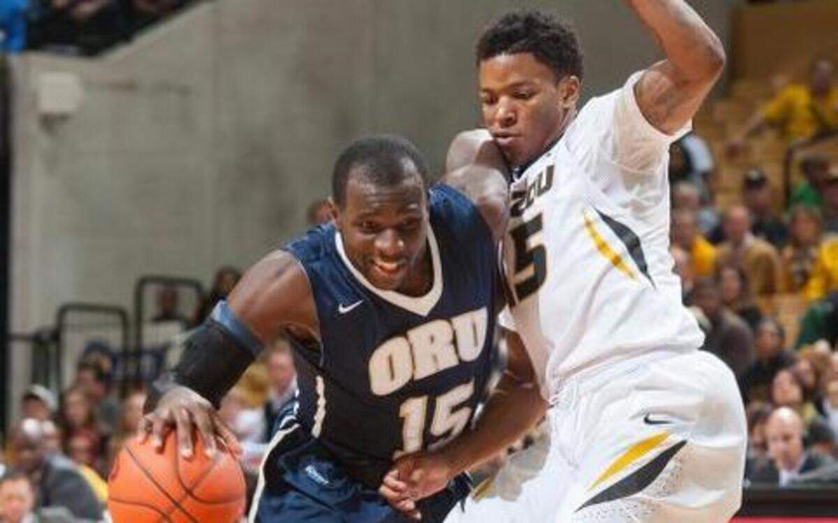 
Oral Roberts’ Obi Emegano (left) pushed past Missouri’s Wes Clark on the way to the basket in the second half Wednesday night in Columbia. Missouri beat the Golden Eagles 78-64.

