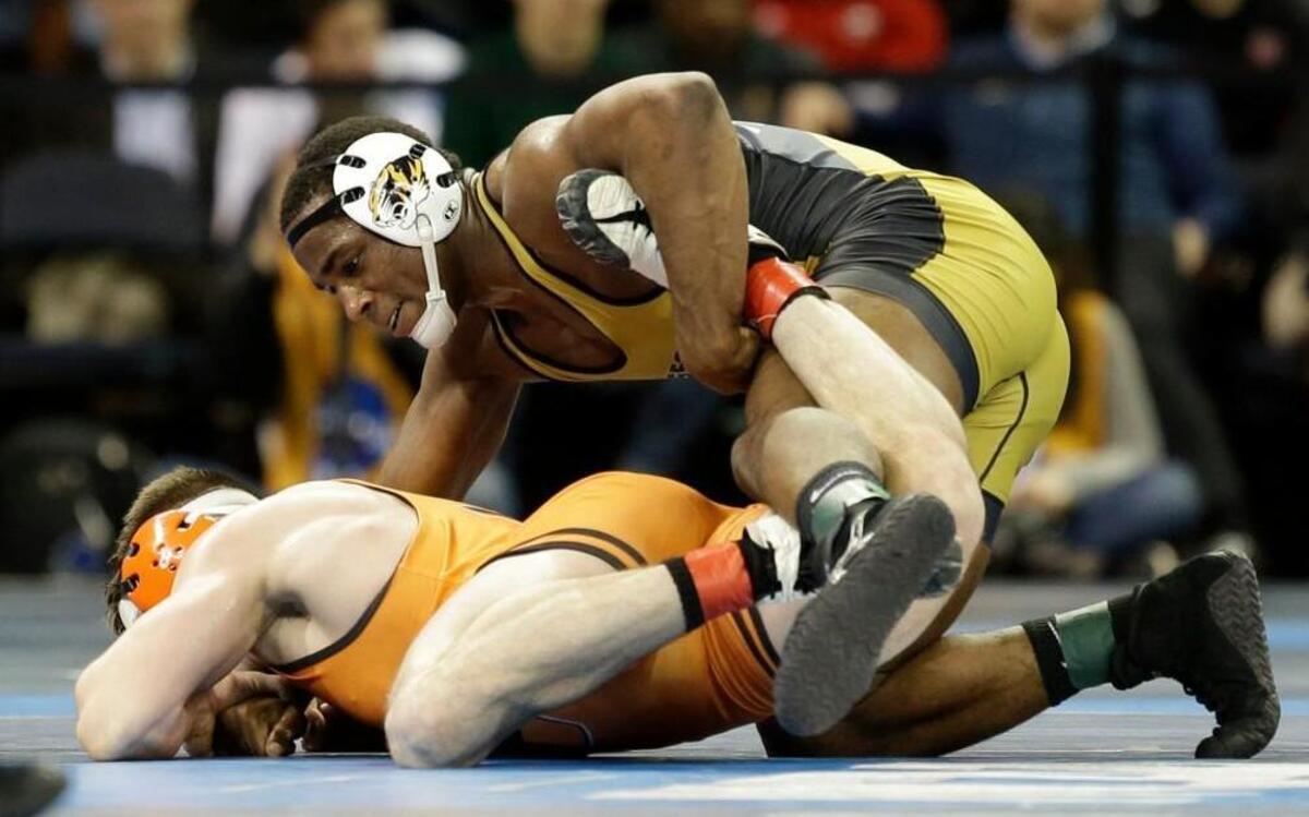 Missouri’s J’den Cox (right) works on Princeton’s Brett Harner in a 197-pound match during the NCAA Division 1 wrestling championships in New York on Friday.