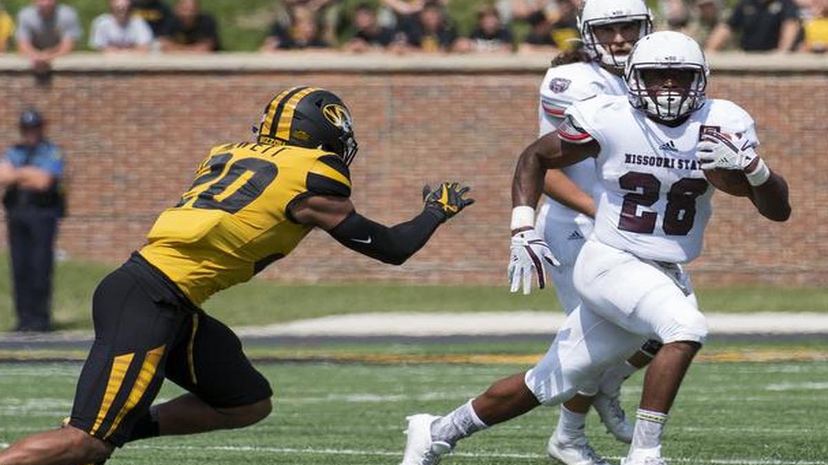 Missouri safety Kaleb Prewett (left) and Logan Cheadle (right) chase Missouri State running back Calan Crowder during the third quarter of an NCAA college football game Saturday, Sept. 2, 2017, in Columbia, Mo. Missouri won 72-43.