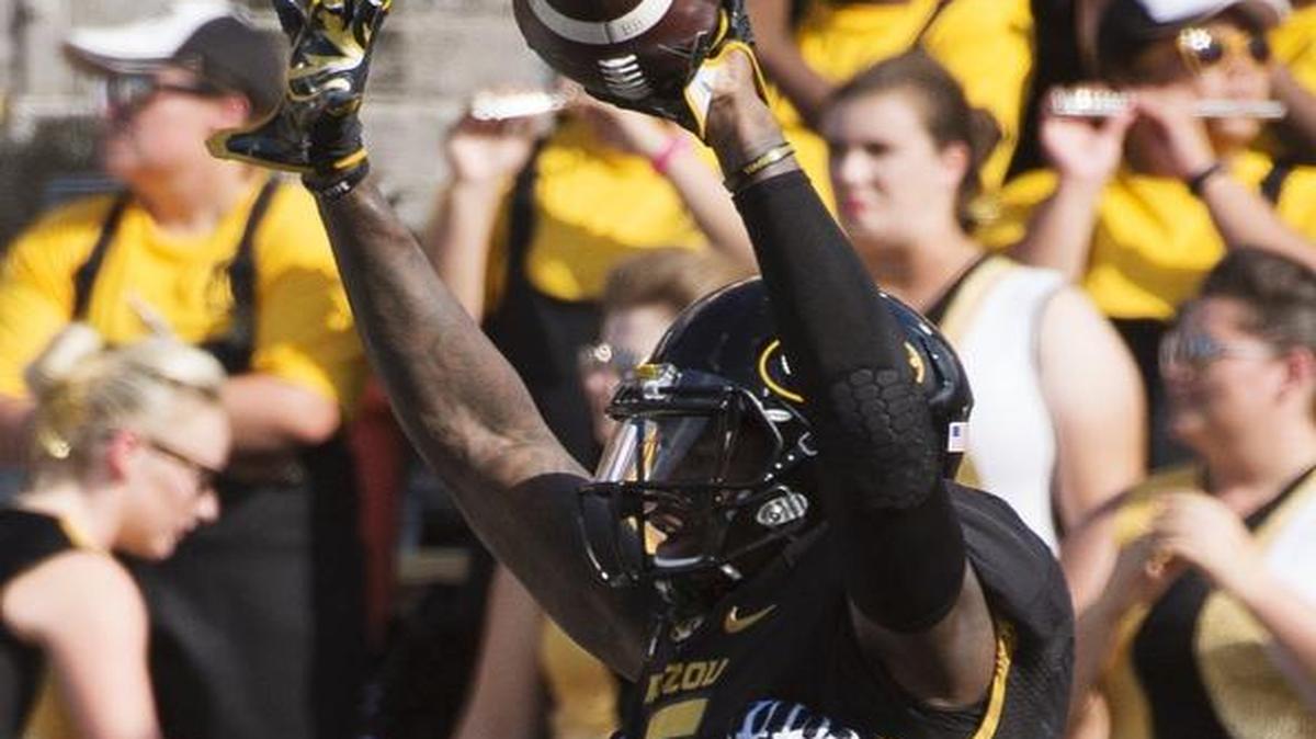 MU wide receiver J’Mon Moore was lifted into the air by teammate Kevin Pendleton after Moore scored in the first quarter Saturday against Delaware State. Moore had a career-high eight catches for 114 yards with a program-record four touchdown receptions.