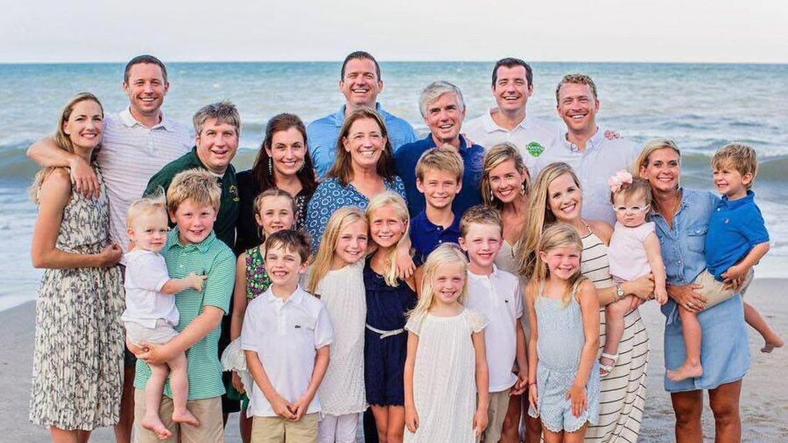 The White family poses for a family photo along a beach in Florida. Back row: Kira White, Mike White (Florida basketball coach), Danny White (UCF athletic director), Brian White (Mizzou deputy athletic director) and Paul Chappell. Middle row: Chris Treadway, Maureen Treadway, Jane White, Kevin White (Duke AD), Mariah Chappell (SMU assistant AD), Paige White and Shawn White.