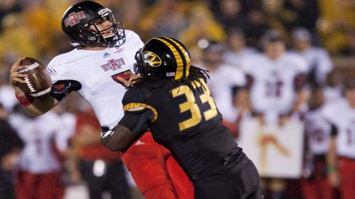 
Missouri’s Markus Golden (right) hit Arkansas State quarterback Adam Kennedy on Sept. 28, 2013, in Columbia.
