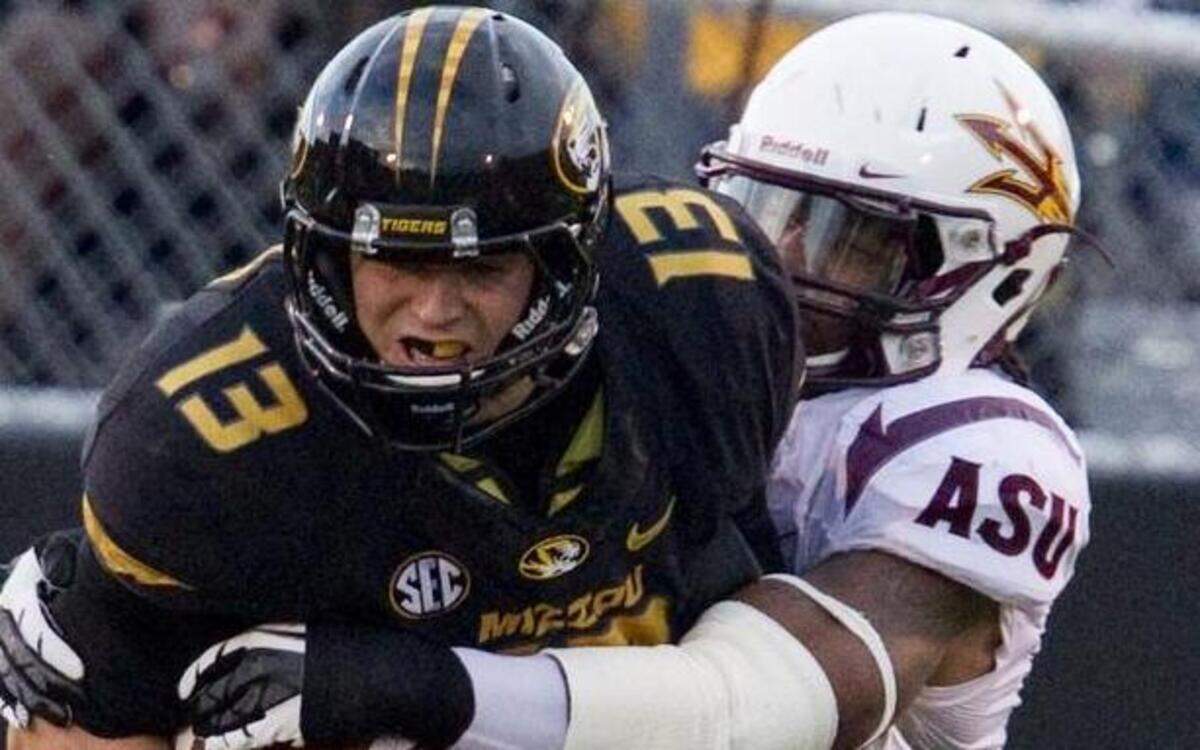 
Missouri Tigers quarterback Corbin Berkstresser (13) was dropped for a loss by Arizona State Sun Devils defensive end Junior Onyeali (5) in the first quarter on September 15, 2012, in Columbia.
