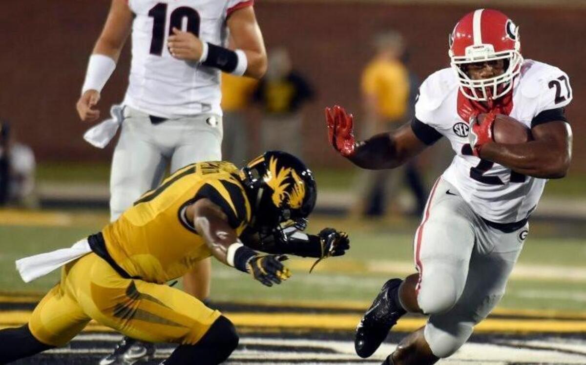 MU cornerback Aarion Penton (left) tried to make a tackle on Georgia running back Nick Chubb in Saturday’s game in Columbia.