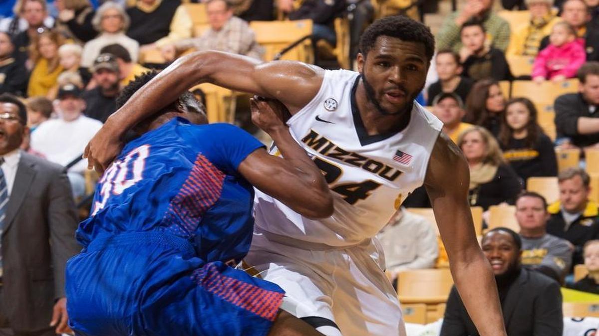 Missouri's Kevin Puryear (right) dribbled around Savannah State's Teslim Idris en route to the basket during Saturday’s college basketball game in Columbia.