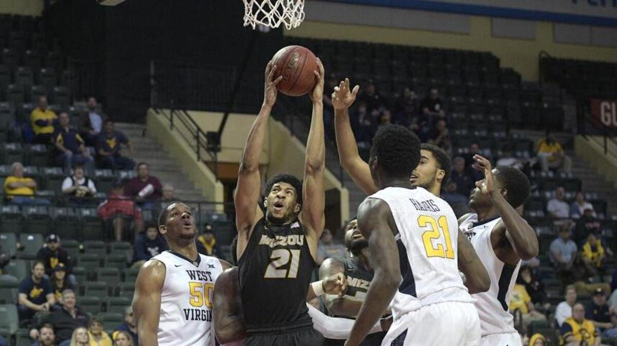 Missouri forward Jordan Barnett (21) grabs a rebound between West Virginia forward Sagaba Konate (50) and forward Wesley Harris (21) during the second half of an NCAA college basketball championship game at the AdvoCare Invitational tournament Sunday. West Virginia won 83-79.