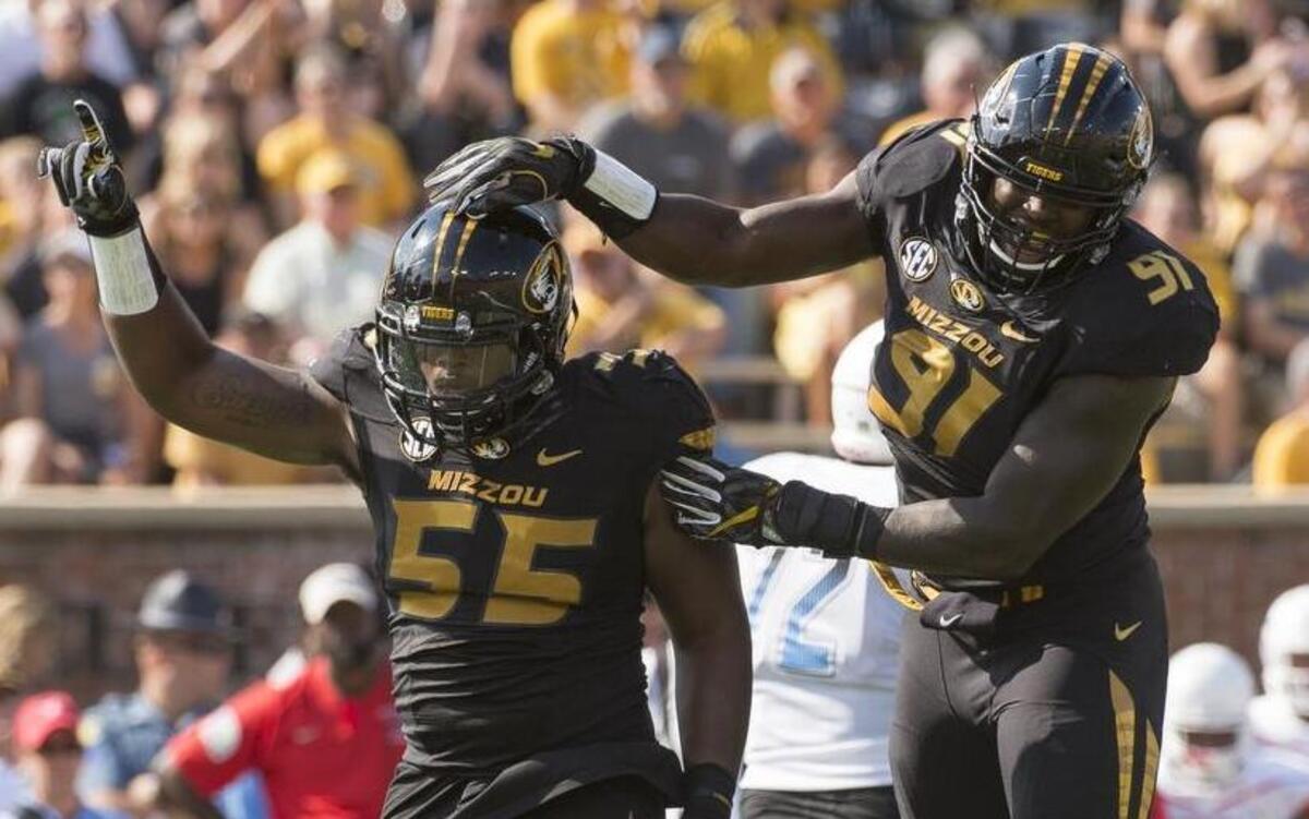 Missouri's Jordan Harold (left) and Charles Harris celebrated after a quarterback sack during the first quarter against Delaware State on Saturday in Columbia.