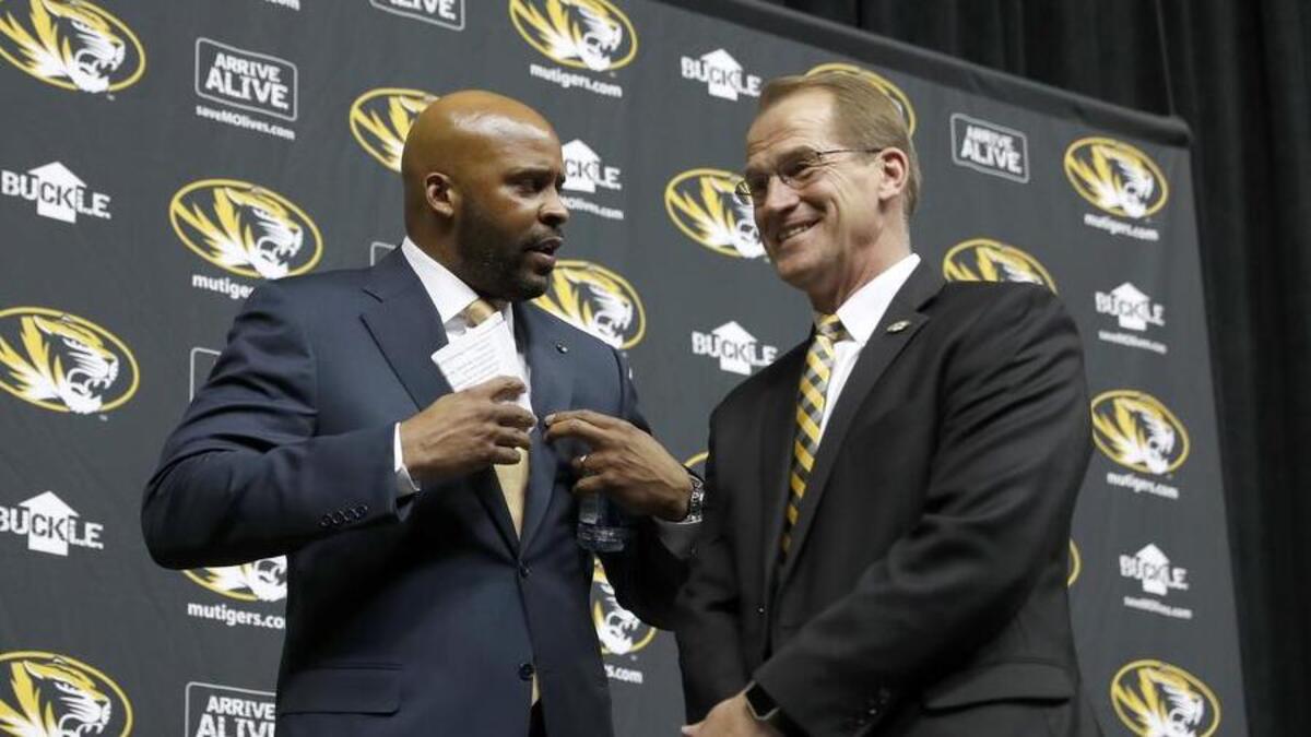 Cuonzo Martin (left) talks with Missouri athletic director Jim Sterk after being formally introduced as the Tigers’ men’s basketball coach March 20, 2017, in Columbia.