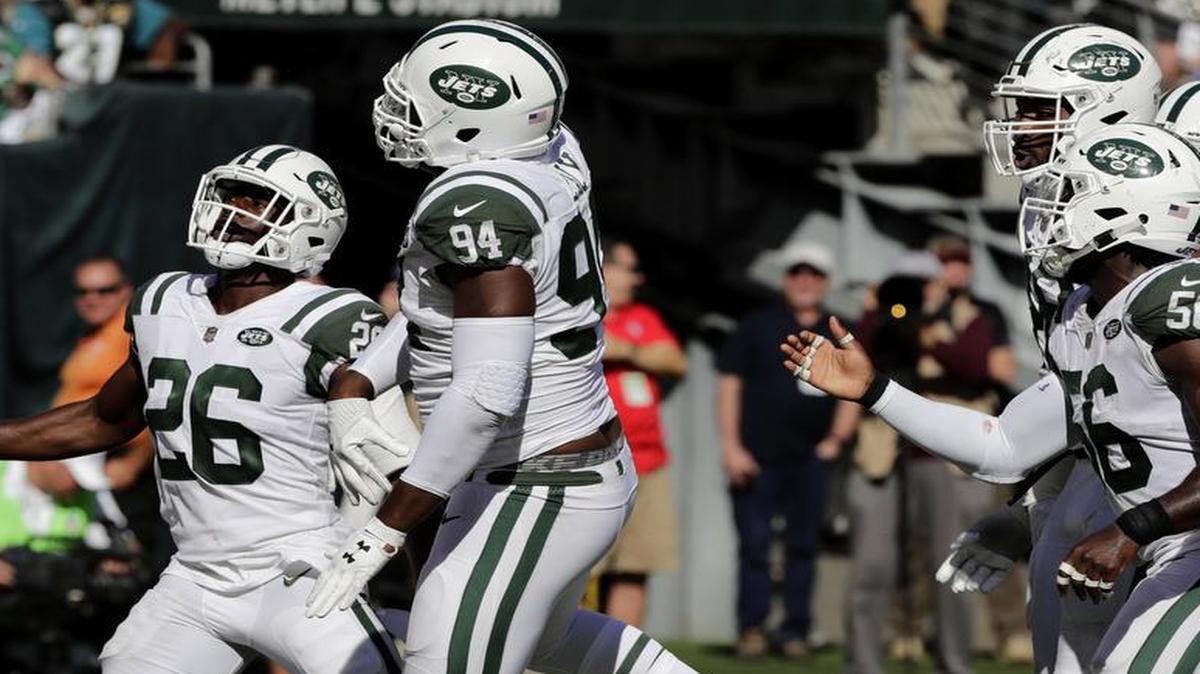 New York Jets lineman Kony Ealy, second from left, celebrates his interception of Jacksonville quarterback Blake Bortles on Sunday.