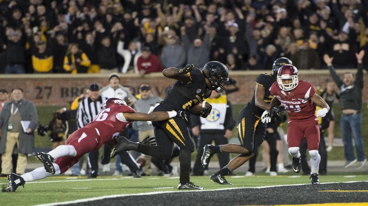 
Missouri Tigers running back Marcus Murphy dragged Arkansas Razorbacks safety Rohan Gaines across the goal line to score the winning touchdown in the fourth quarter on Nov. 28 at Faurot Field in Columbia, Mo. Missouri beat Arkansas 21-14 to claim its second consecutive SEC East Division Championship.
