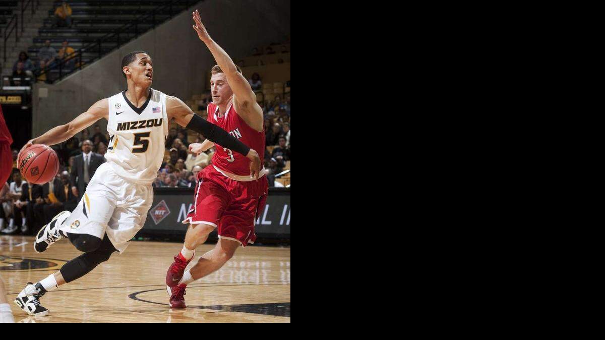 
Missouri's Jordan Clarkson, left, drives around Davidsonâ€™s Brian Sullivan as he moves toward the basket during the first half of an NCAA college basketball game in the first round of the NIT, Tuesday, March 18, 2014, in Columbia, Mo.
