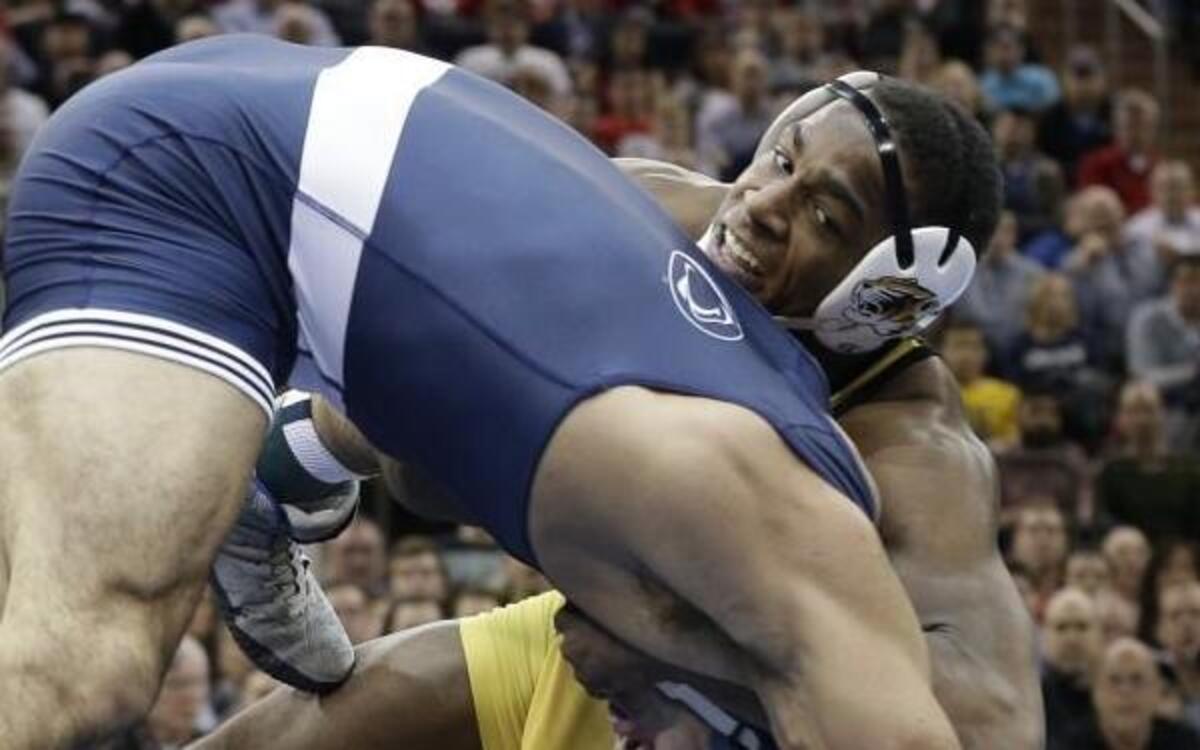 Missouri wrestler J’den Cox (right)