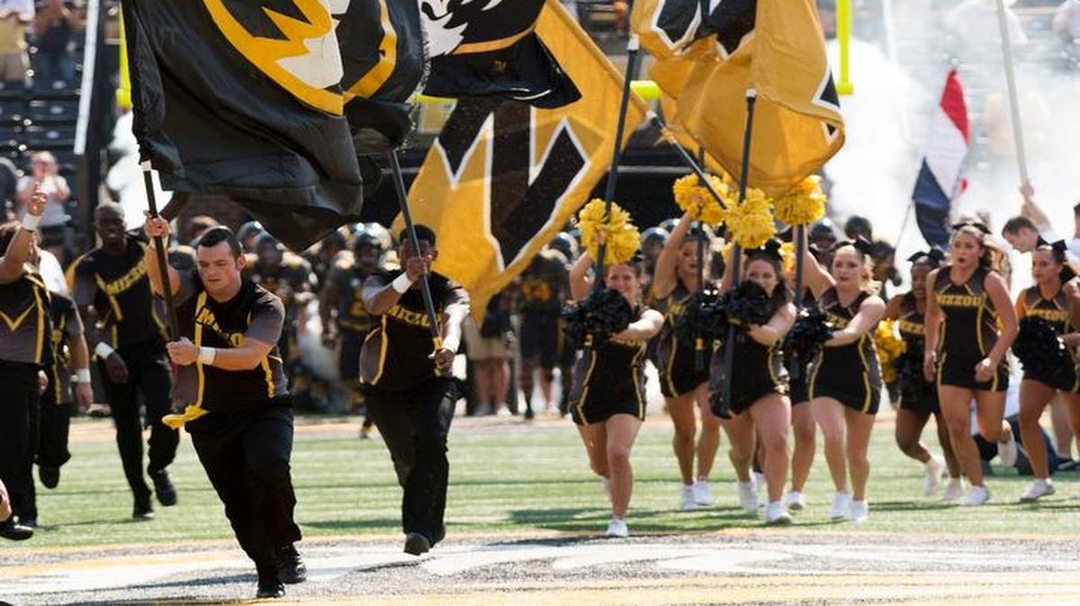 The Missouri cheerleaders lead the football team to the field before the start of last weekend’s game against Purdue.