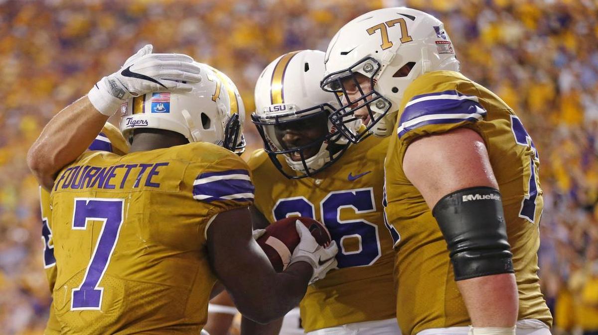 LSU running back Leonard Fournette (from left) celebrated a touchdown with teammates Jazz Ferguson and Ethan Pocic.