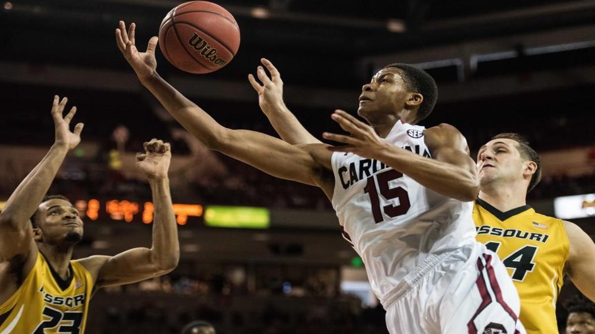 South Carolina guard P.J. Dozier (15) drove to the hoop between Missouri forward Jakeenan Grant (23) and Ryan Rosberg in the first half Saturday in Columbia, S.C.