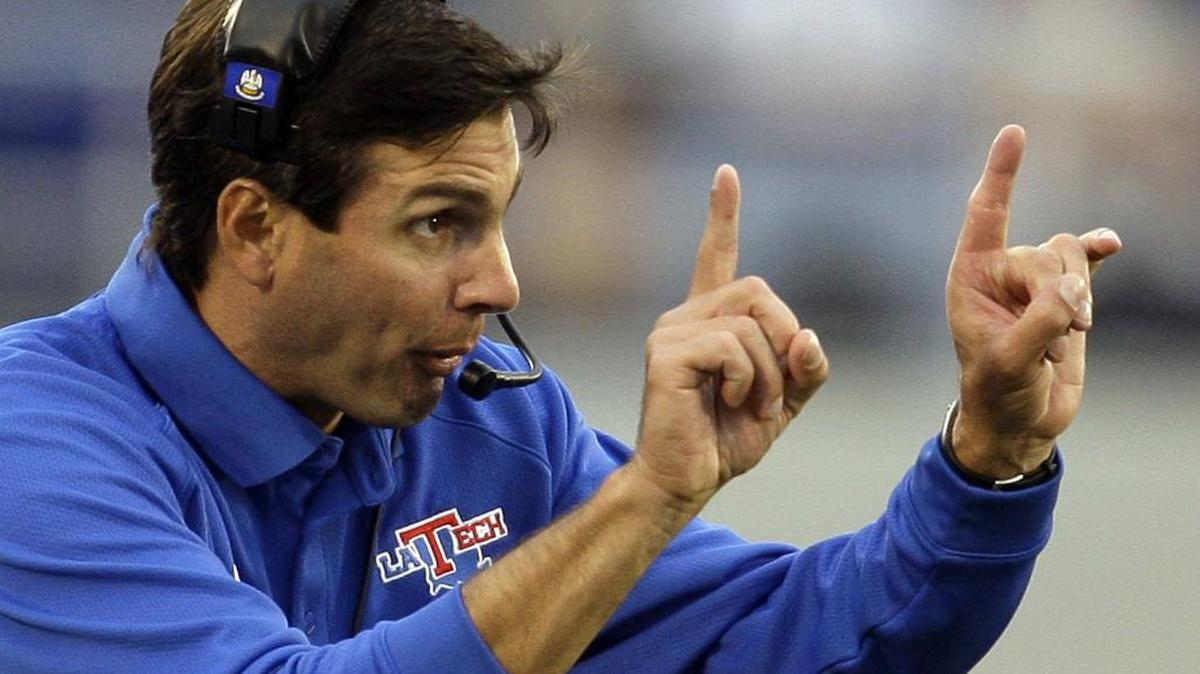 FILE - In this Sept. 12, 2009, file photo, Louisiana Tech coach Derek Dooley signals to his players during the second half of an NCAA college football game against Navy in Annapolis, Md.