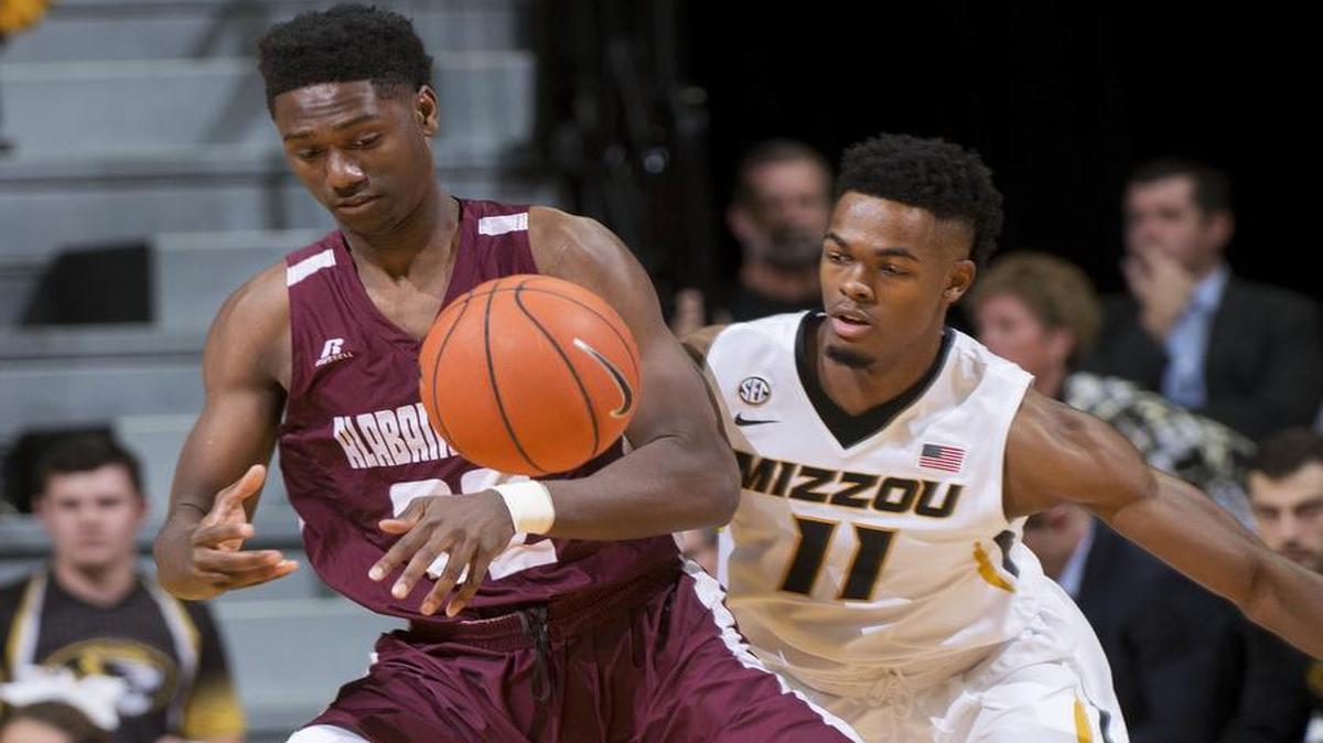 Alabama A&M’s Eugene Jones Jr (left) had the ball knocked away by Missouri’s K.J. Walton during a Nov. 13 game.