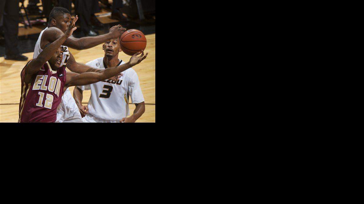 Elon's Christian Hairston, left, battles Missouri's D'Angelo Allen, top left, for a rebound in front of Johnathan Williams III during the first half of an NCAA college basketball game Thursday, Dec. 11, 2014, in Columbia, Mo.